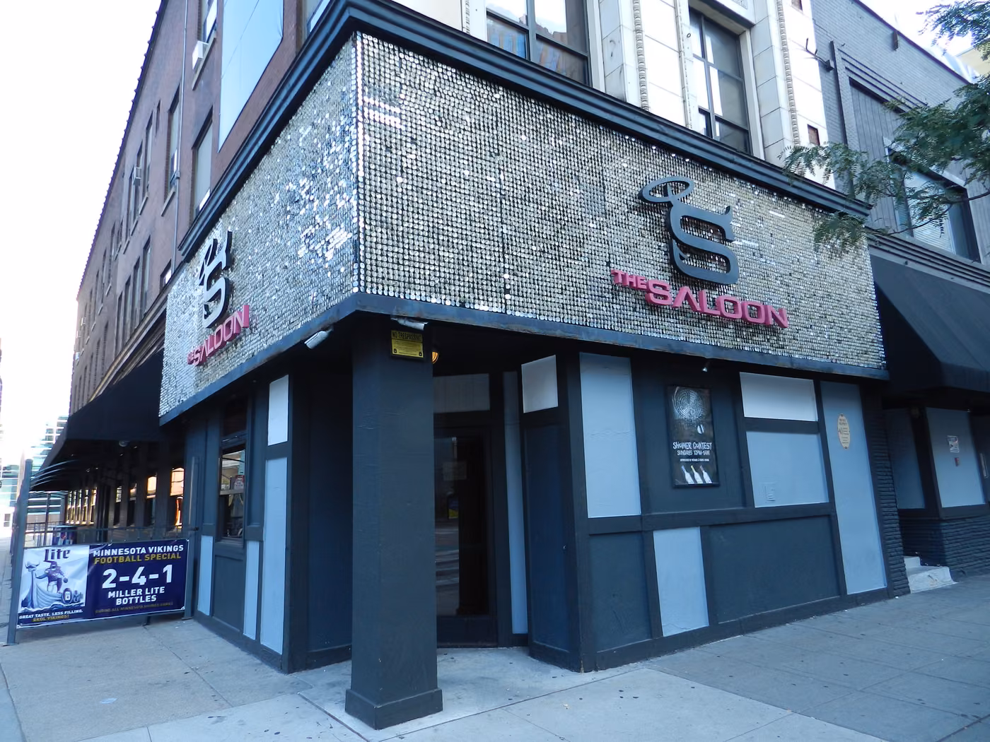 Silver-fronted exterior of The Saloon on a downtown Minneapolis corner.